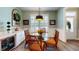 Inviting dining area with glass top table, stylish chairs, built-in bar, and large windows for natural light at 3997 Aspera Dr, Summerville, SC 29483