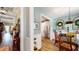 Hallway view to dining room with white cabinets, stainless steel appliances, and bright interior at 3997 Aspera Dr, Summerville, SC 29483