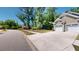 Inviting home featuring a two-car garage, lush green trees, and paved driveway at 3997 Aspera Dr, Summerville, SC 29483