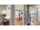 Hallway view of the kitchen boasting white cabinets and stainless steel appliances at 3997 Aspera Dr, Summerville, SC 29483