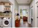Hallway featuring hardwood floors, access to bedroom and laundry room with washer and dryer at 3997 Aspera Dr, Summerville, SC 29483