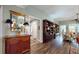 Inviting hallway with beautiful wood floors, a decorative mirror, and a glimpse into a cozy living space at 3997 Aspera Dr, Summerville, SC 29483