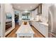 Bright, contemporary kitchen with white cabinets, stainless steel appliances, and large central island at 3997 Aspera Dr, Summerville, SC 29483