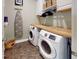Functional laundry room with washer, dryer, butcher block countertop, and ample storage space at 3997 Aspera Dr, Summerville, SC 29483