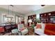Living room with bookshelves, natural light, hardwood floors, and view of the dining area at 3997 Aspera Dr, Summerville, SC 29483