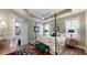 Bright main bedroom featuring tray ceiling, plantation shutters, and ensuite bathroom access at 3997 Aspera Dr, Summerville, SC 29483
