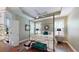 Bright main bedroom featuring tray ceiling, plantation shutters, and hardwood floors at 3997 Aspera Dr, Summerville, SC 29483