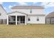 View of the house with a screened-in patio and a large green backyard at 413 Ribiero Dr, Summerville, SC 29486
