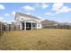 Fenced backyard with screened-in patio and spacious grassy area for recreation at 413 Ribiero Dr, Summerville, SC 29486