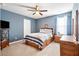 Cozy bedroom with blue walls, carpet, wood furniture, TV, and ample natural light creating a serene retreat at 413 Ribiero Dr, Summerville, SC 29486