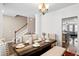 Open-concept dining area with wood table, upholstered chairs, and seamless flow to the kitchen at 413 Ribiero Dr, Summerville, SC 29486