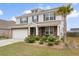 Charming two-story home with stone accents, a two-car garage, and lovely landscaping at 413 Ribiero Dr, Summerville, SC 29486