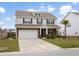 Beautiful home with stone details, an attached garage, and a well-manicured lawn at 413 Ribiero Dr, Summerville, SC 29486