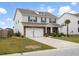 Well-maintained two-story house with stone detail, a garage, and neatly kept grounds at 413 Ribiero Dr, Summerville, SC 29486