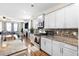 Modern kitchen with white cabinets, granite counters, mosaic backsplash, and stainless steel appliances at 413 Ribiero Dr, Summerville, SC 29486