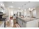 Bright kitchen with stainless steel appliances, gray cabinets, and granite countertops offers plenty of workspace at 413 Ribiero Dr, Summerville, SC 29486
