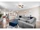Open-concept living room with a large sectional sofa, ottoman, and view into the kitchen at 413 Ribiero Dr, Summerville, SC 29486