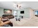 Comfortable living room with a ceiling fan, a plush brown sofa, TV, and glass coffee table perfect for relaxing at 413 Ribiero Dr, Summerville, SC 29486
