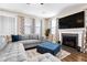 Comfortable living room featuring a plush sectional sofa, fireplace, and large television at 413 Ribiero Dr, Summerville, SC 29486