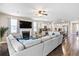 Open concept living room and kitchen with a cozy fireplace and large sectional sofa at 413 Ribiero Dr, Summerville, SC 29486