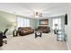 Spacious living room featuring a ceiling fan, two leather sofas, and an entertainment center with natural light at 413 Ribiero Dr, Summerville, SC 29486