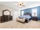 Spacious primary bedroom featuring a blue accent wall, plush carpeting, and a ceiling fan at 413 Ribiero Dr, Summerville, SC 29486