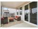 Relaxing screened-in patio with comfortable seating and neutral patterned rug at 413 Ribiero Dr, Summerville, SC 29486