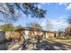 A brick home with an outdoor kitchen, grill, patio, and trampoline in the backyard under a sunny sky at 4437 Garwood Dr, Ladson, SC 29456