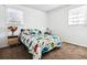 A bedroom with a full bed, a night stand, two windows, and carpet flooring at 4437 Garwood Dr, Ladson, SC 29456
