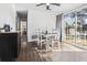 A dining area with white chairs, a ceiling fan, a sliding glass door, and dark wood flooring at 4437 Garwood Dr, Ladson, SC 29456