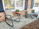 Cozy front porch seating area with landscaping and a brick facade at 4437 Garwood Dr, Ladson, SC 29456