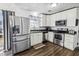 A kitchen with stainless steel appliances, white cabinets, a window, and dark wood flooring at 4437 Garwood Dr, Ladson, SC 29456