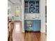 Bar area with a blue cabinet, sink and beverage fridge, as well as white backsplash at 49 Ashley Ave, Charleston, SC 29401