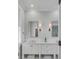 Bathroom with white vanity and sinks with neutral walls and trim at 49 Ashley Ave, Charleston, SC 29401