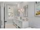 Bright bathroom featuring double sinks, large mirrors, marble countertops, and natural light at 49 Ashley Ave, Charleston, SC 29401