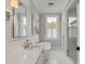 Bright bathroom with soaking tub, marble countertop, and modern fixtures at 49 Ashley Ave, Charleston, SC 29401