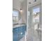 Stylish bathroom with blue vanity, round mirror, glass shower, and toilet, showcasing modern design at 49 Ashley Ave, Charleston, SC 29401
