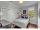 Cozy bedroom with hardwood floors, a comfortable bed, and view of a tree at 49 Ashley Ave, Charleston, SC 29401