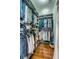 Walk-in closet with extensive shelving, hanging rods, and hardwood flooring at 49 Ashley Ave, Charleston, SC 29401