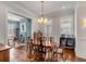 Dining room featuring hardwood floors, classic furnishings, and views into a cozy living space at 49 Ashley Ave, Charleston, SC 29401