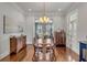 Formal dining room with wood floors, chandelier, and decorative buffet cabinets at 49 Ashley Ave, Charleston, SC 29401