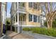 Lovely two-story home with a beautiful yard, porch, black shutters, and charming curb appeal at 49 Ashley Ave, Charleston, SC 29401
