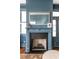 Cozy fireplace with blue mantel, herringbone firebox, and decorative mirror, adding charm to the home at 49 Ashley Ave, Charleston, SC 29401