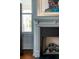 A fireplace with a decorative mantel and a window showing the outdoor pillars at 49 Ashley Ave, Charleston, SC 29401