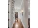 Hallway with hardwood floors leading to the front door and staircase at 49 Ashley Ave, Charleston, SC 29401