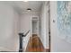 Hallway with white walls and ceilings, dark trim and fixtures, and wood floors at 49 Ashley Ave, Charleston, SC 29401