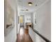Bright hallway with hardwood floors, neutral walls, and decorative lighting at 49 Ashley Ave, Charleston, SC 29401