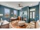 A stylish home office features a fireplace, rich blue walls, and a cozy seating area with hardwood floors at 49 Ashley Ave, Charleston, SC 29401