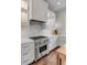 Close-up of modern kitchen with stainless steel appliances and white cabinets at 49 Ashley Ave, Charleston, SC 29401