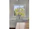 Modern kitchen sink area with natural light from large window offering verdant outdoor view at 49 Ashley Ave, Charleston, SC 29401